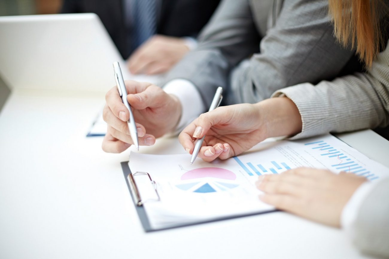 Colleagues analyzing financial charts