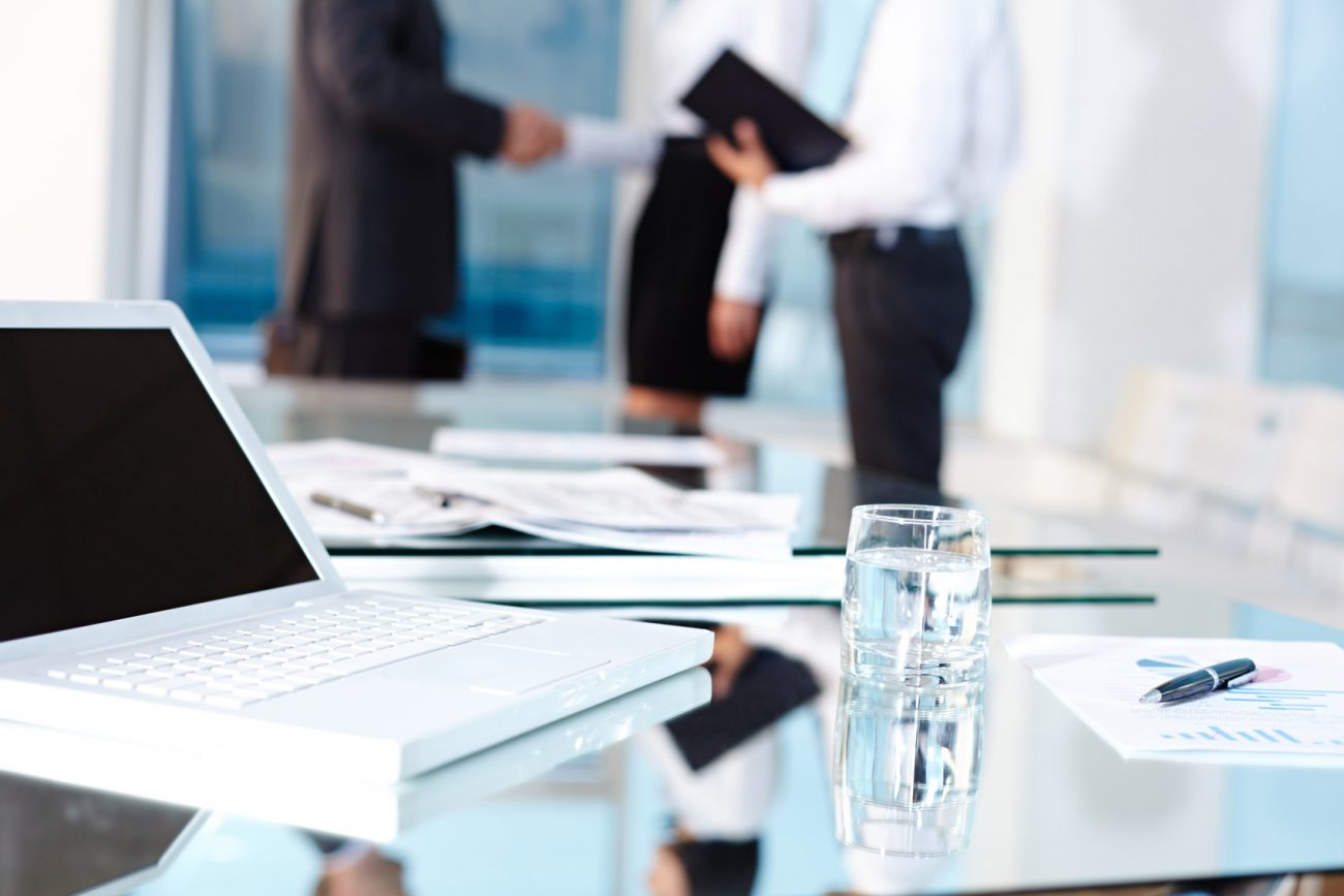 Laptop and glass on table