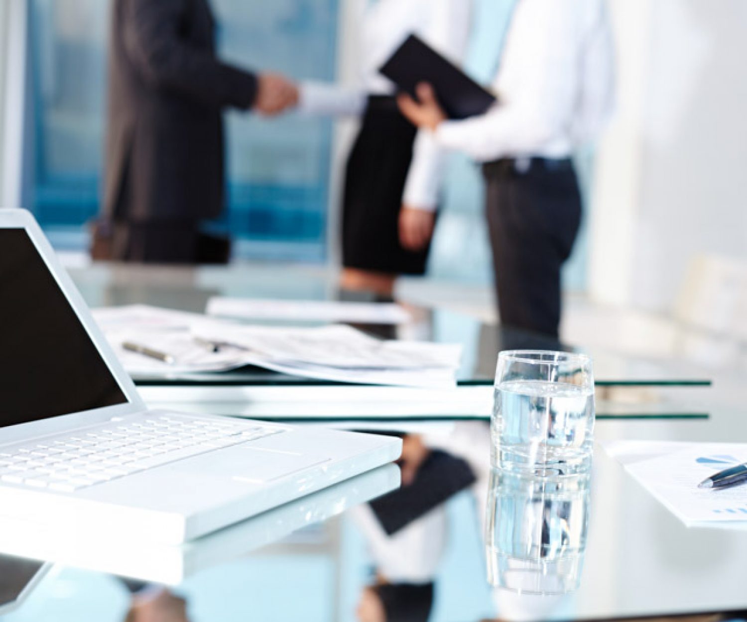 Laptop and glass on table
