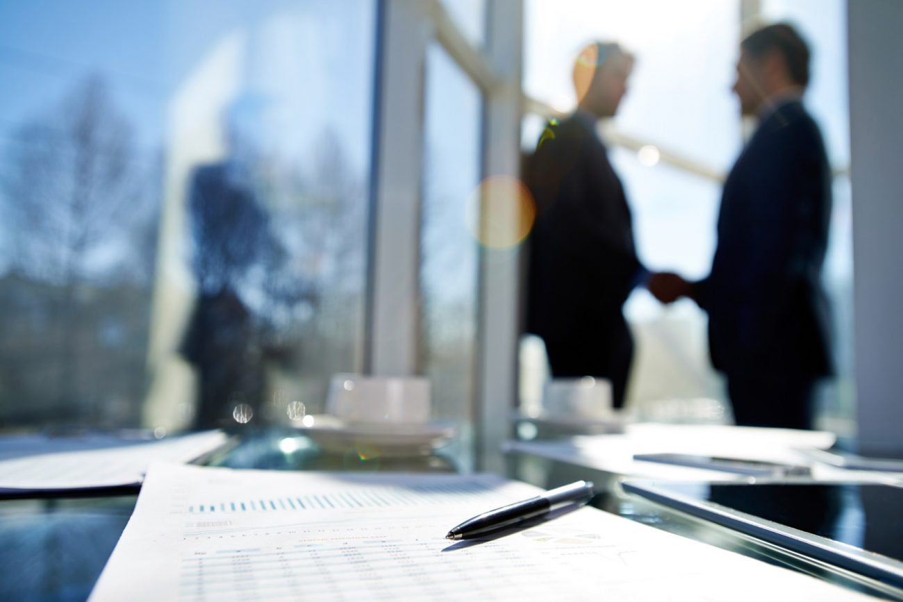 photo of businessmen shaking hands after meeting